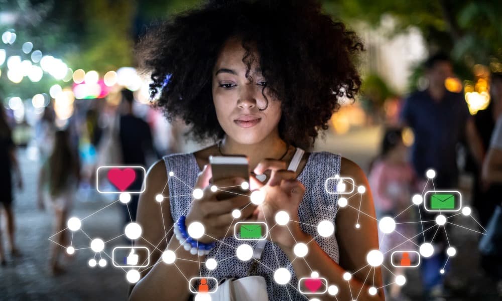 A woman using a smartphone to access different social media platforms to find the best non Facebook dating apps.